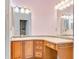 Bathroom vanity featuring granite counters, double mirrors, and plenty of storage at 10843 Lakeshore Dr, Clermont, FL 34711