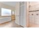 Bright bathroom featuring a soaking tub, walk-in shower, and bi-fold closet at 10843 Lakeshore Dr, Clermont, FL 34711