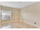 Bedroom with neutral walls, trim, and a window overlooking the backyard at 10843 Lakeshore Dr, Clermont, FL 34711