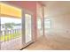Light-filled bedroom with balcony access and water views at 10843 Lakeshore Dr, Clermont, FL 34711