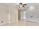 Neutral bedroom with a ceiling fan, double closet and marble tile flooring at 10843 Lakeshore Dr, Clermont, FL 34711