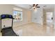 Bonus room with treadmill and bright neutral floors at 10843 Lakeshore Dr, Clermont, FL 34711