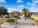 Beautiful property with a secure gated entrance, lush landscaping, and well manicured lawn with waterfront views at 10843 Lakeshore Dr, Clermont, FL 34711