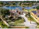 Beautiful exterior of a lakeside home with a private dock, lush green lawn, mature trees, and backyard pool at 10843 Lakeshore Dr, Clermont, FL 34711