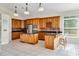 Large kitchen with island, wooden cabinetry, stainless appliances and bar seating at 10843 Lakeshore Dr, Clermont, FL 34711