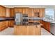 Spacious kitchen with stainless steel appliances, custom cabinetry, and a large island at 10843 Lakeshore Dr, Clermont, FL 34711