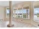 Bright living room with large windows offering serene views at 10843 Lakeshore Dr, Clermont, FL 34711