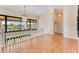 Open-concept living area with hardwood floors, high ceilings, and expansive windows showcasing the beautiful outdoors at 10843 Lakeshore Dr, Clermont, FL 34711
