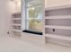 Bright office with built-in shelves, a window bench, and modern tile floors at 10843 Lakeshore Dr, Clermont, FL 34711