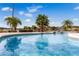 Sparkling pool with waterfall features and lush tropical landscaping, perfect for relaxing and entertaining outdoors at 10843 Lakeshore Dr, Clermont, FL 34711