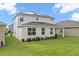 Two-story home with solar panels and grassy backyard at 224 Trinity Ridge Cir, Davenport, FL 33897