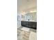 Bathroom featuring double vanity, dark cabinets, and wood look flooring at 224 Trinity Ridge Cir, Davenport, FL 33897