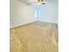 Spacious carpeted bedroom featuring a ceiling fan and bright window at 224 Trinity Ridge Cir, Davenport, FL 33897
