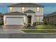 Charming two-story home with a two-car garage and well-maintained landscaping at 224 Trinity Ridge Cir, Davenport, FL 33897