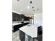 Bright, modern kitchen with black cabinets and a large center island with seating at 224 Trinity Ridge Cir, Davenport, FL 33897