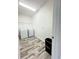 Bright laundry room with wood-look tile flooring and modern washer and dryer at 224 Trinity Ridge Cir, Davenport, FL 33897