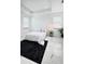 Bright main bedroom with tile flooring, tray ceiling, and two windows at 224 Trinity Ridge Cir, Davenport, FL 33897