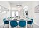 Bright dining room features a modern chandelier, seating for eight, and white walls at 7487 Gathering Dr, Reunion, FL 34747