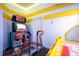 Modern arcade game with neon lights and a comfortable chair at 7487 Gathering Dr, Reunion, FL 34747