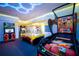 Fun game room with several arcade games and a vibrant atmosphere at 7487 Gathering Dr, Reunion, FL 34747