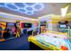 Amusing game room featuring arcade games and neon ceiling lights at 7487 Gathering Dr, Reunion, FL 34747