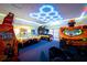 Entertaining game room featuring arcade games and unique neon ceiling lights at 7487 Gathering Dr, Reunion, FL 34747