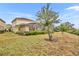 Large backyard with grassy area and landscaping at 6078 Broad Oak Dr, Davenport, FL 33837