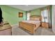 Relaxing bedroom with king-size bed and green walls at 6078 Broad Oak Dr, Davenport, FL 33837