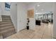 Bright entryway with stairs leading upstairs and view into living room at 6078 Broad Oak Dr, Davenport, FL 33837
