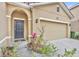 House entrance with a dark gray door and attached two-car garage at 6078 Broad Oak Dr, Davenport, FL 33837