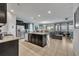 Open kitchen features granite countertops, stainless steel appliances, and dark wood cabinets at 6078 Broad Oak Dr, Davenport, FL 33837