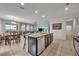 Kitchen island with seating, granite countertops, and stainless steel appliances at 6078 Broad Oak Dr, Davenport, FL 33837