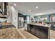 Modern kitchen with granite countertops, stainless steel appliances, and an island at 6078 Broad Oak Dr, Davenport, FL 33837