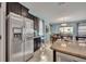 Stainless steel refrigerator in kitchen with granite counters and dark cabinets at 6078 Broad Oak Dr, Davenport, FL 33837