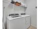 Bright laundry room with washer, dryer, and shelving at 6078 Broad Oak Dr, Davenport, FL 33837