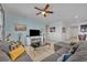 Living room features gray sectional sofa, coffee table and ceiling fan at 6078 Broad Oak Dr, Davenport, FL 33837