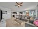 Spacious living room featuring a large sectional sofa and a view into the kitchen at 6078 Broad Oak Dr, Davenport, FL 33837
