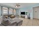 Open living area with sectional sofa, fireplace and large windows at 6078 Broad Oak Dr, Davenport, FL 33837