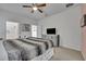 Main bedroom with a large bed, TV, and walk-in closet at 6078 Broad Oak Dr, Davenport, FL 33837
