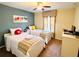 This kid-themed bedroom showcases two twin beds, colorful decor, and a ceiling fan for a playful, comfortable space at 8953 California Palm Rd, Kissimmee, FL 34747