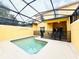 Enclosed pool area with light concrete, patio seating, and a black safety fence at 8953 California Palm Rd, Kissimmee, FL 34747