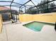 Enjoy a private splash in this caged in pool, featuring a sun lounger and a bright yellow exterior wall at 8953 California Palm Rd, Kissimmee, FL 34747