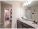 Well-lit bathroom with granite counters and a view into an adjacent themed bedroom at 4189 Lana Ave, Davenport, FL 33897