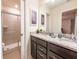 Bathroom featuring double sinks with granite countertops and a glass-enclosed shower at 4189 Lana Ave, Davenport, FL 33897