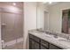 Bright bathroom featuring a double vanity, granite countertop, and glass-enclosed shower at 4189 Lana Ave, Davenport, FL 33897