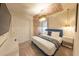 Comfortable bedroom with a striking blue accent bed frame, wood accent wall, and stylish chandelier lighting at 4189 Lana Ave, Davenport, FL 33897