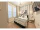 Comfortable bedroom with modern chandelier, soft natural light, and stylish wall accents at 4189 Lana Ave, Davenport, FL 33897