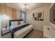 Modern bedroom with a unique light fixture, chic wall decor, and a comfortable bed at 4189 Lana Ave, Davenport, FL 33897