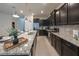Modern kitchen featuring dark cabinets, stainless steel appliances, and granite countertops at 4189 Lana Ave, Davenport, FL 33897