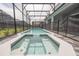 Relax in the screened-in pool and spa with a safety fence that provides privacy and peace of mind at 4189 Lana Ave, Davenport, FL 33897